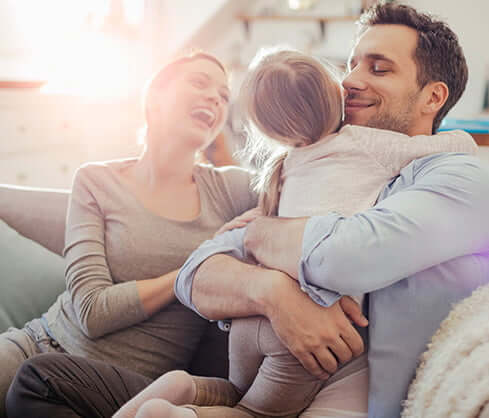 Mom, dad, and baby happy and smiling