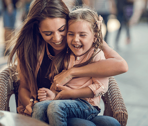 mom and daughter smiling