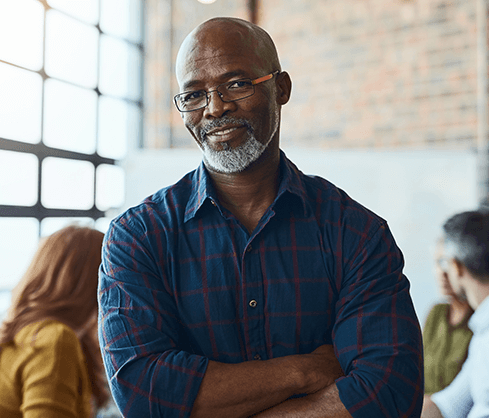 man smiling with crossed arms