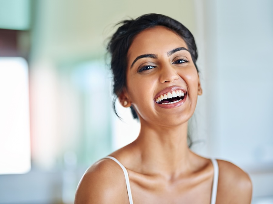 smiling woman, women's oral health and hormones